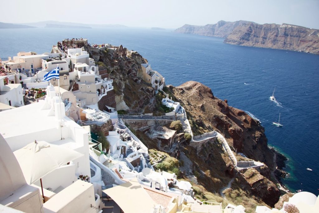 Top 5 Cities to Visit in 2020 featured by top US travel blog, Points with Q: image of Santorini Greece