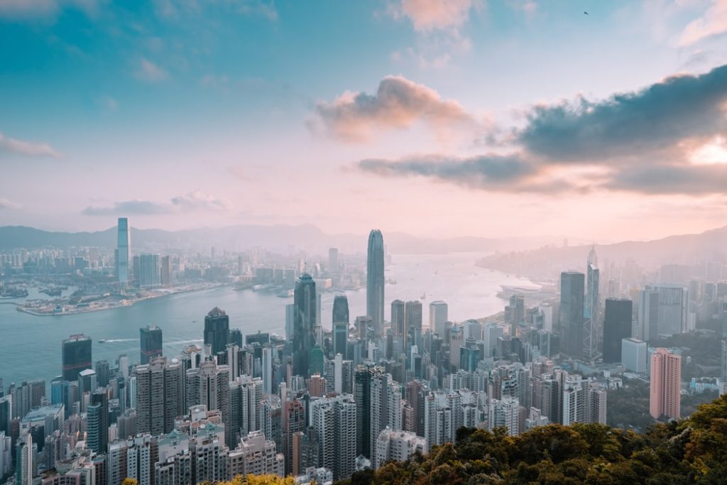 Best Ways to Fly to Asia featured by top US travel hacker, Points with Q: Image of Hong Kong Island Buildings 
