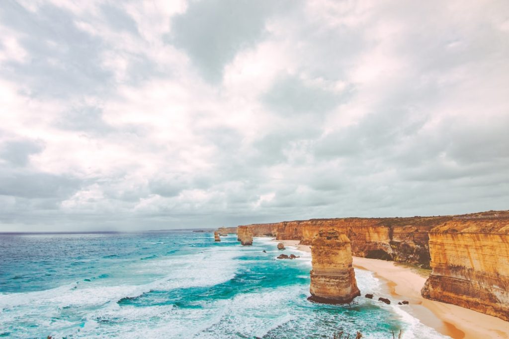 Best Ways to Fly to Australia from the USA featured by top US travel hacker, Points with Q: Image of Twelve Apostles Princetown Australia