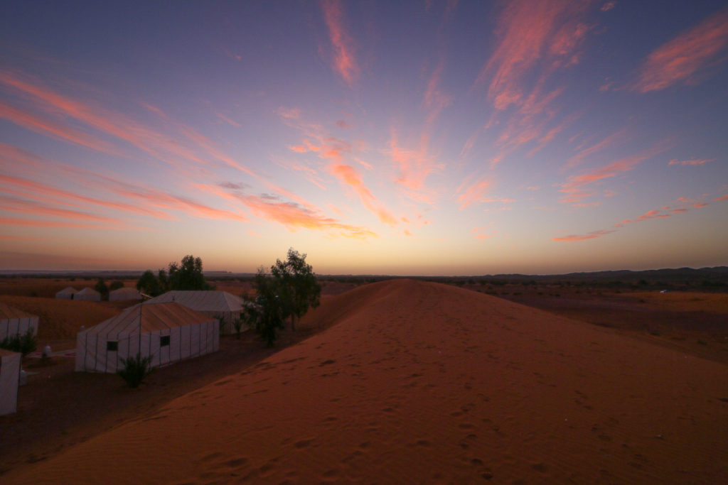 Sahara Desert Morocco, a travel guide featured by top US travel blog, Points with Q: Image of Sahara Desert Sunrise