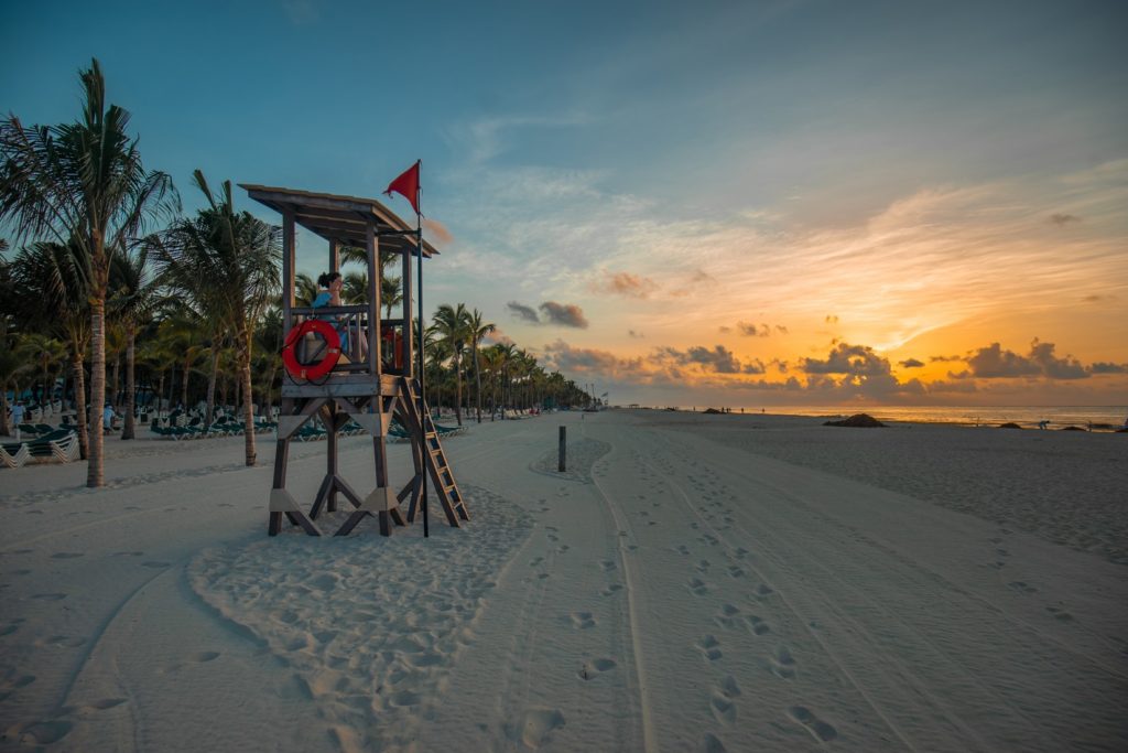 Tips to earn the most Citi Prestige travel credit featured by top US travel hacker, Points with Q: image of Playa del Carmen Lifeguard Beach