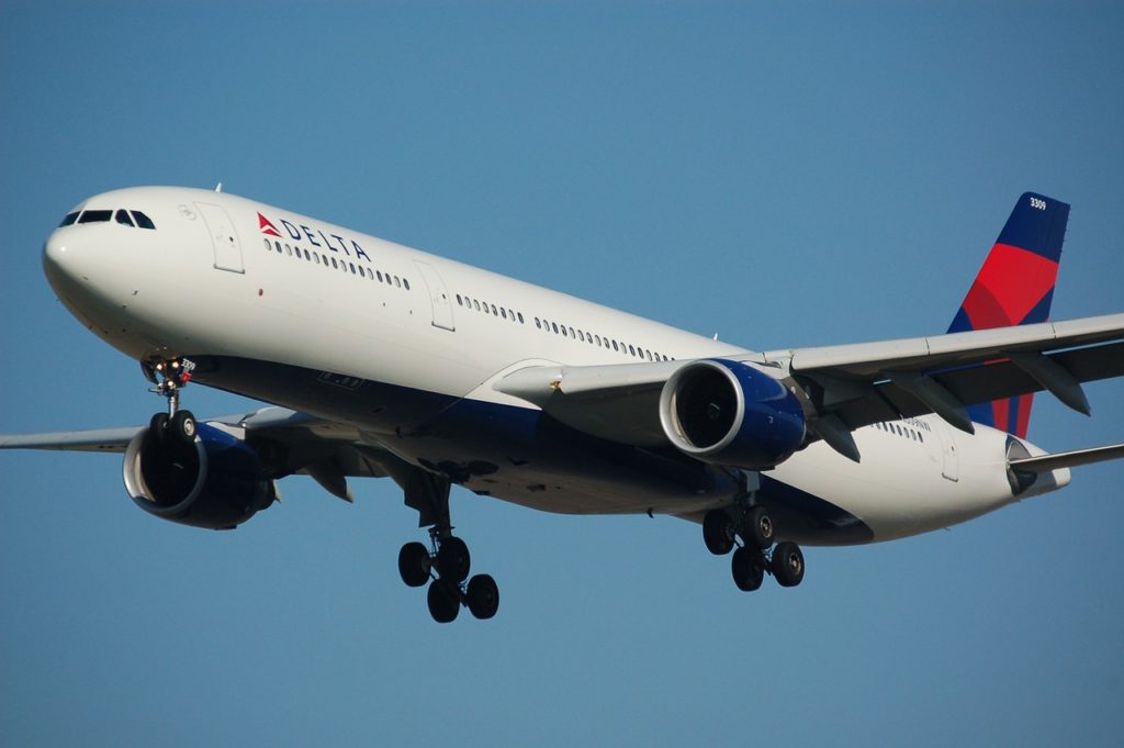Turks and Caicos Travel Guide featured by top US travel blog, Points with Q: image of Delta Air Lines Plane