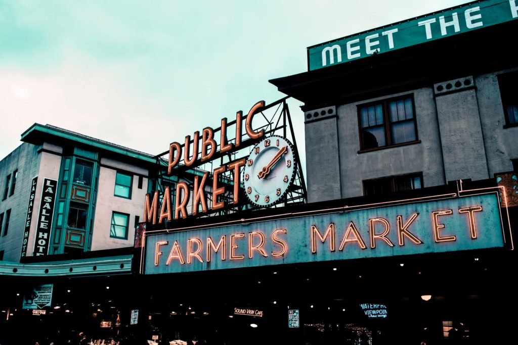 Seattle Travel: Places to Visit in Seattle in 48 Hours featured by top US travel blog, Points with Q: image Seattle Pike Place Public Market Sign