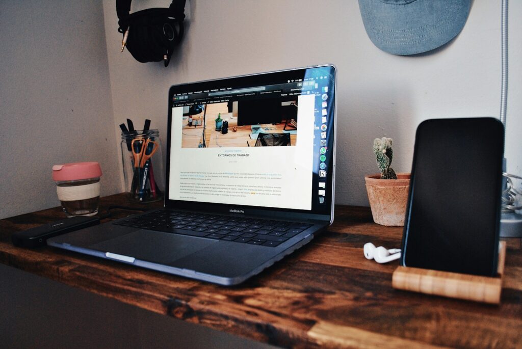 black laptop computer on brown wooden table