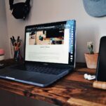 black laptop computer on brown wooden table