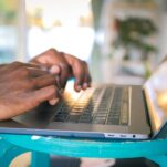 person using silver laptop computer