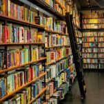 a long row of books on shelves in a library